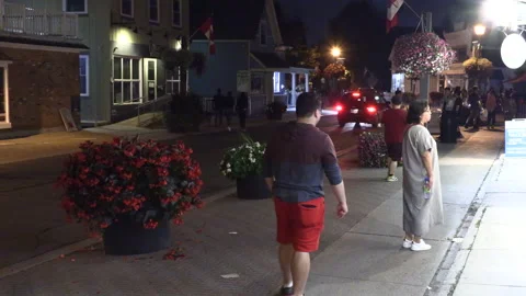 Warm ummer night with people walking and restaurant patios open post COVID 19 Stock Footage 158478483