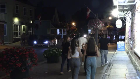 Warm ummer night with people walking and restaurant patios open post COVID 19 Stock Footage 158480001
