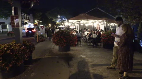 Warm ummer night with people walking and restaurant patios open post COVID 19 Vídeo Stock 158491164