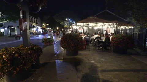 Warm ummer night with people walking and restaurant patios open post COVID 19 Vídeo Stock 158493134