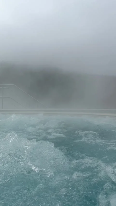Warm water of a thermal pool generating fog in a cold day Stock Footage 307227905