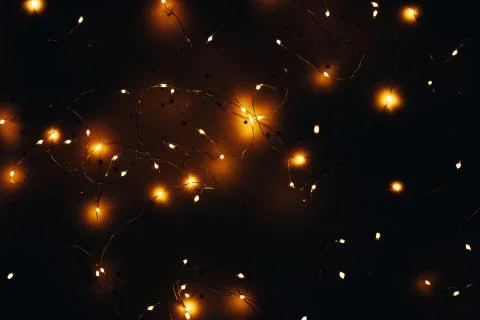 Warm white led string lights black background Stock Photos