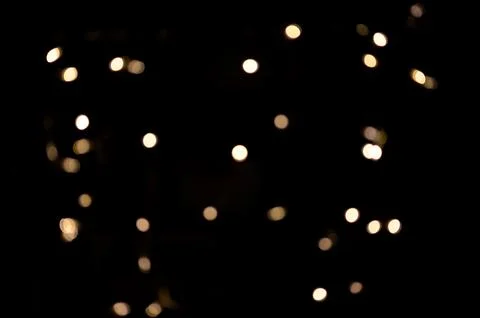 Warm white small real single color bokeh or soft out of focus blurred lights Stock Photos