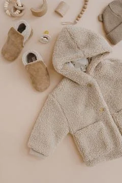 Warm winter children's jacket, suede booties, hat, pacifier, toys. Baby cloth Stock Photos