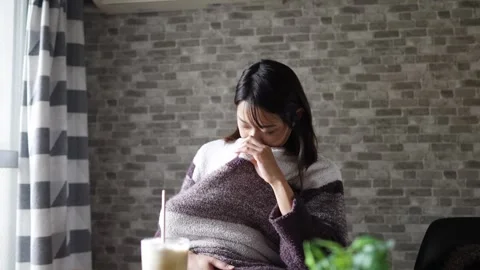 In a warm winter room, a 6-month-old Japanese baby girl wearing fluffy clothes Vídeos de archivo 296932464