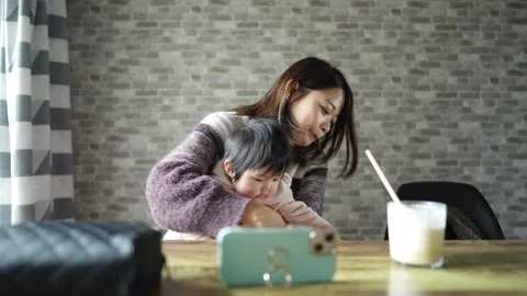 In a warm winter room, a 6-month-old Japanese baby girl wearing fluffy clothes Stock-Footage 296982566