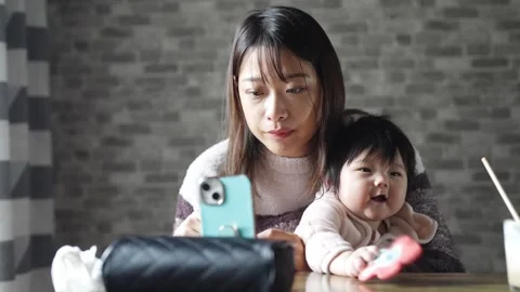 In a warm winter room, a 6-month-old Japanese baby girl wearing fluffy clothes Video stock 296988346