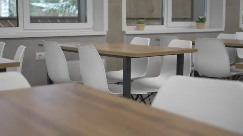 Warm wood-look table surface pairs with sturdy plastic chair 動画素材 314884111