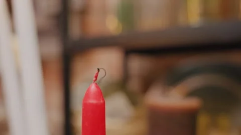 Warm workshop with glowing candle. Flickering red light in cozy florist studio Stock Footage 334066608