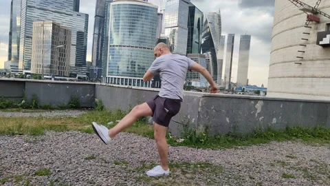 Warm-up of a young man.  Vertical twisting. Stock Footage 201303319