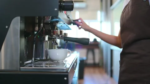 Warming up a cup of coffee before pouring it Stock Footage 255996449