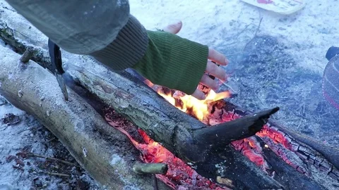 Warming gloved hand on fire Stock Footage 71273438