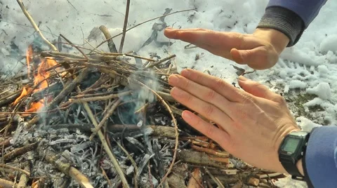 Warming hands on campfire Stock Footage 47654741