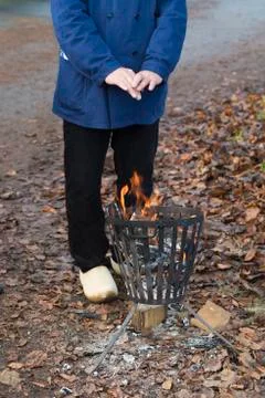 Warming hands on fire pit Stock Photos