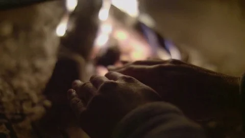 Warming hands in front of fireplace Stock Footage 81409855