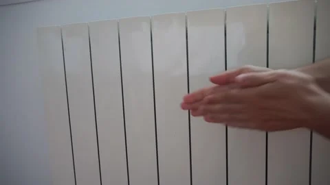 Warming hands up on heating radiator. Cold winter. No gas concept Video stock 221028412