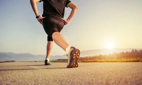 Warming up runner on the road close up image Stock Photos