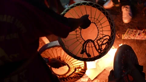The warmth of the fire glows next to the drum used in devotional performances. Stock Footage 318094642