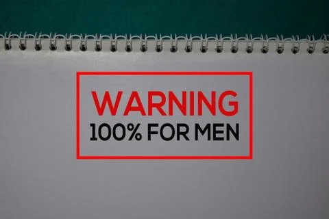 Warning 100% For Men write on a book isolated on green background. Stock Photos