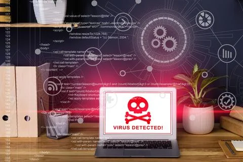 Warning about virus attack on laptop screen. Workplace in office Stock Photos