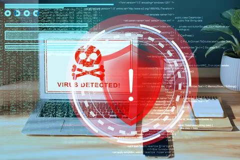 Warning about virus attack on laptop screen. Workplace in office Stock Photos