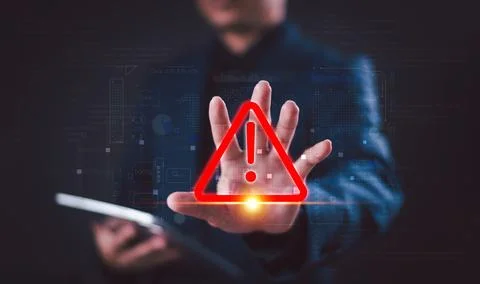 Warning alert icon concept. Programmer or developer use computer tablet to pr Stock Photos