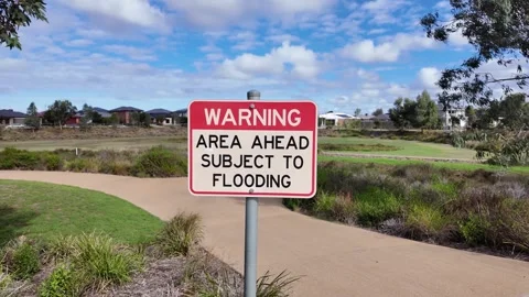 "WARNING AREA AHEAD SUBJECT TO FLOODING" sign in Melbourne Australia Stock Footage 335965016
