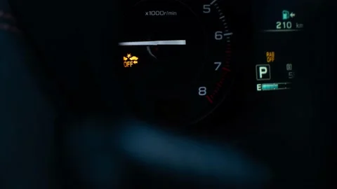 Warning check engine light going on and off on a car dash board Stock Footage 233844574