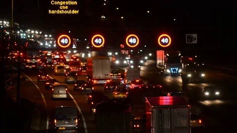 Warning gantry lights of speed restriction in traffic jam on the M62 motorway uk Stock Footage 82683768