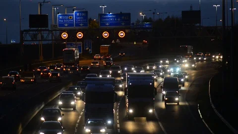 Warning gantry lights of speed restriction in traffic jam on the M62 motorway uk Stock Footage 82683792