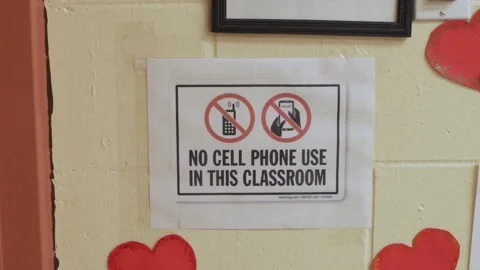 Warning information that a cell phone is not used in this class . Stock Footage 136447333