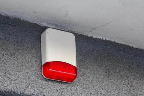 Warning light mounted on wall indicating alert situation in urban area Stock Photos