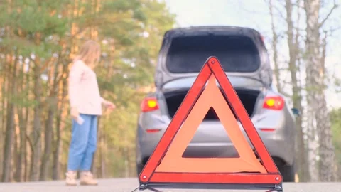 Warning red triangle. Gray car with flashing emergency light along the road 스톡 동영상 164496374