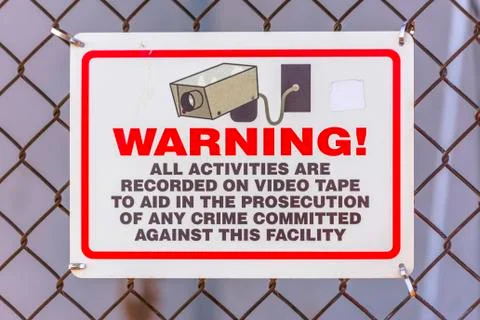 Warning security camera sign on a chain link fence Stock Photos