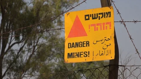 Warning sign against old landmines in Golan Heights, Israel Stock Footage