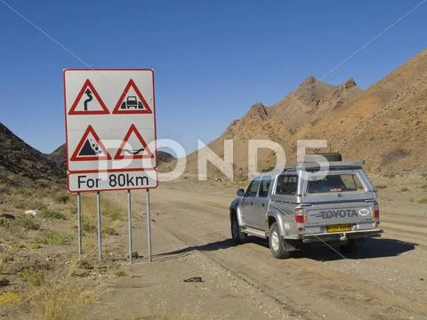 Warning Sign And Toyota Hilux Off-Road Vehicle On The C13 North Of Rosh Pinah
