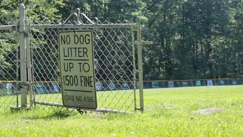 Warning Sign on baseball Field Reads No Dog Litter Stock Video Stock Footage