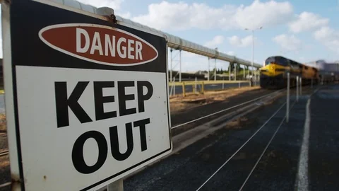 Warning sign with blurred moving train in background. Stock Footage 93276387