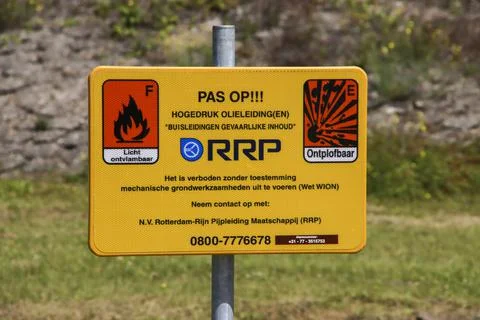 Warning sign for explosion or fire risk with Oil pipe in the ground Stock Photos