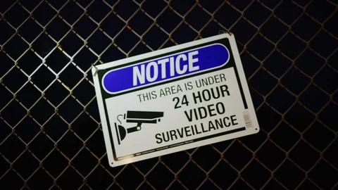 Warning sign on a grid in abandoned area, this area is under surveillance Video stock 128544262