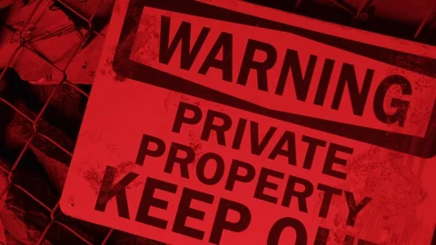 Warning sign on a grid in abandoned area, warning private property keep out Stock Footage 128544680