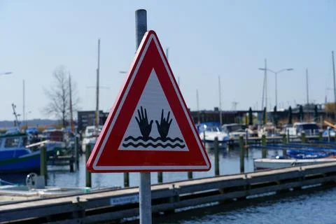 Warning sign on a harbor in a triangular shape with a red border 스톡 사진