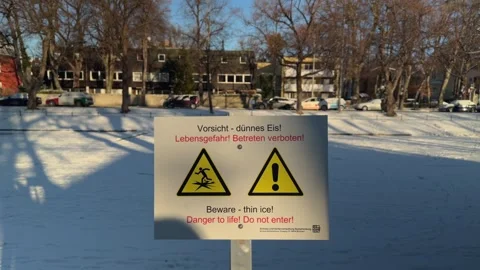 Warning sign in Muenchen, Germany, cautioning about thin ice on the Nymphenburg Stock Footage 325732596