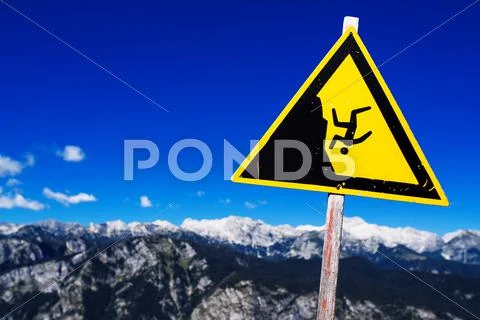 Warning sign - possible fall from the mountain cliff Stock Photos