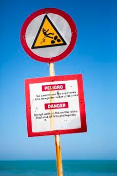 Warning sign preventing not to walk on rocks in Cartagena Stock Photos