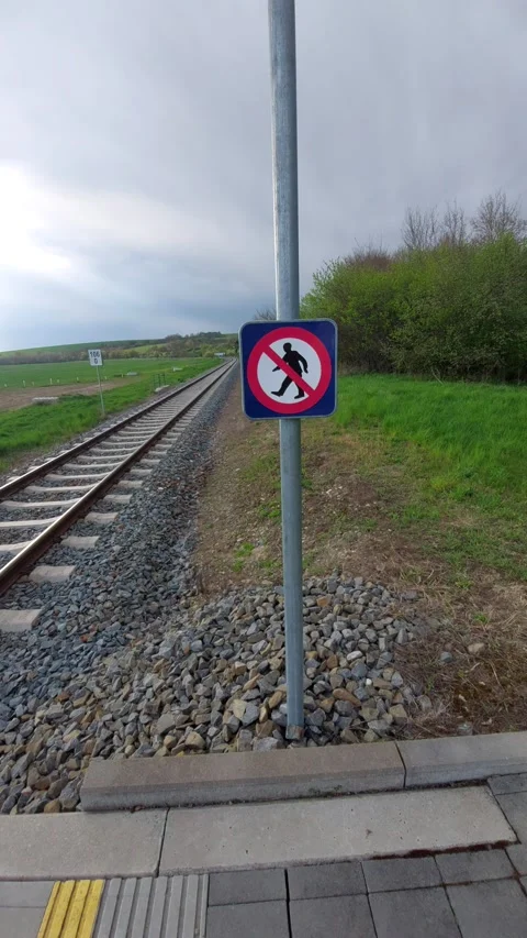 Warning Sign Prohibiting Pedestrian Entry on Train Platform Next to Railway Trac Stock Footage 334177564