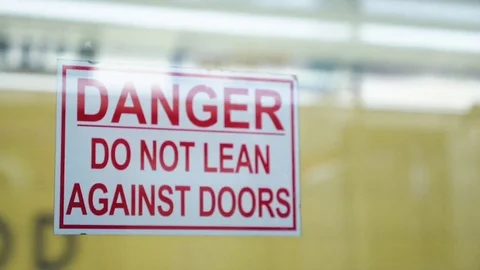 Warning sign saying Do Not Lean Against Doors on moving subway Stock Footage 82367316