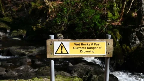 Warning sign by waterfalls Stock Footage 150749912