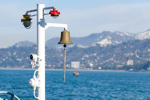 The warning system on deck of ship - lamps of signal lights and the bronze bell. Stock-Fotos