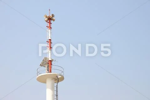 Warning tower tsunami on blue sky... Stock Photos